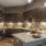 a kitchen with a bar and a refrigerator