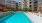 a swimming pool in a courtyard between buildings