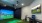 a room with a large screen and a tv on the wall
